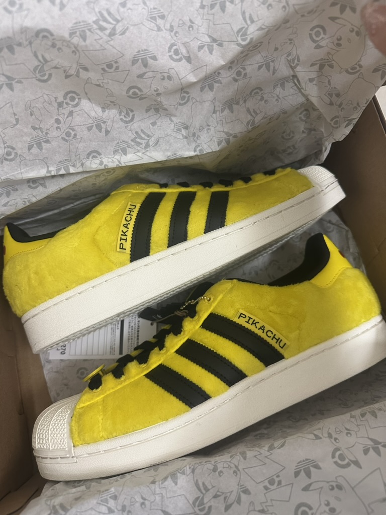 Side view of Pikachu adidas sneakers in the box